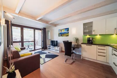 a kitchen and living room with a couch and a table at Villa Floris in Bressanone