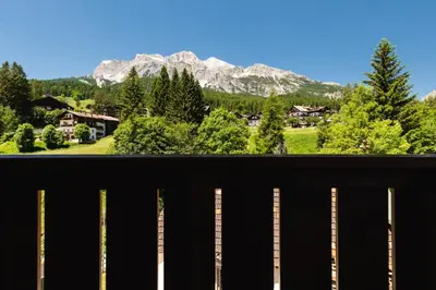 a view from a balcony with mountains in the background at Hotel Pontechiesa in Cortina dʼAmpezzo