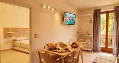 a bedroom with a bed and a television and a chandelier at Centro Storico di Merano in Merano
