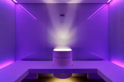 a purple room with a stool with a light on it at Art & Design Hotel Napura in Bolzano