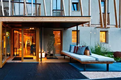 a couch sitting on a patio in front of a building at Art & Design Hotel Napura in Bolzano