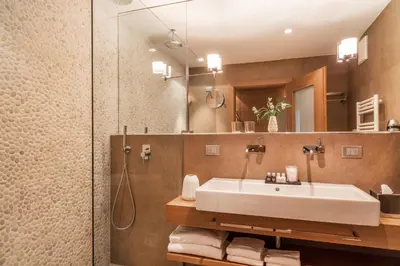 a bathroom with a sink and a shower at Art & Design Hotel Napura in Bolzano