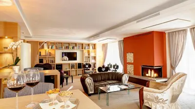 a living room with a couch and a table at Art & Design Hotel Napura in Bolzano