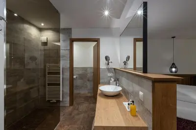 a bathroom with a sink and a toilet and a tub at Diamant Spa Resort in Santa Cristina in Val Gardena