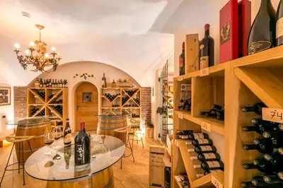 a wine tasting room with a table with wine bottles at Diamant Spa Resort in Santa Cristina in Val Gardena