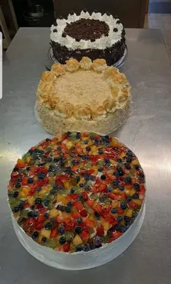 two cakes with fruit on them sitting on a table at gasthof pension rössl in Nova Ponente