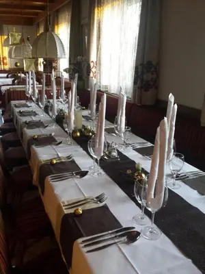 a long table with white table cloths and candles on it at gasthof pension rössl in Nova Ponente