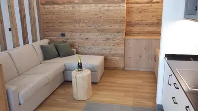 a living room with a couch and a table at App. Villa Fraina in San Cassiano