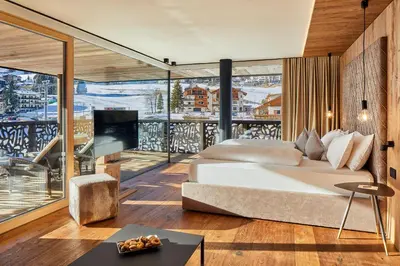 a bedroom with a large bed and a balcony at Hotel Christiania in La Villa