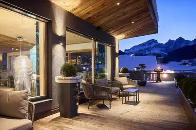 a house with a deck with a view of mountains at Hotel Christiania in La Villa