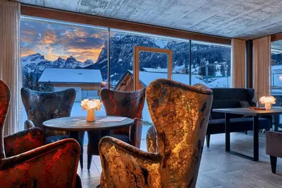 a room with chairs and tables and a large window at Hotel Christiania in La Villa