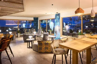 a restaurant with tables and chairs and a table at Hotel Christiania in La Villa