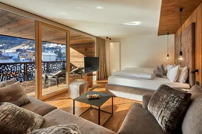 a hotel room with a bed and a balcony at Hotel Christiania in La Villa