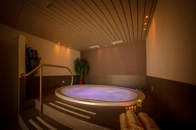 a large bath tub in a bathroom with aperature at Dominik Alpine City Wellness Hotel - Adults only in Bressanone