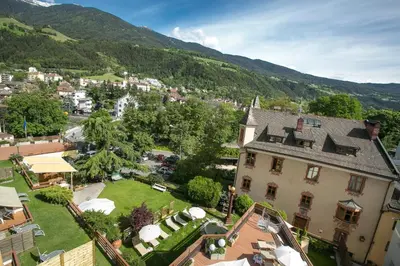 an aerial view of a town with a large house at Dominik Alpine City Wellness Hotel - Adults only in Bressanone