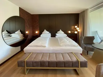 a dining room with white tables and chairs at Dominik Alpine City Wellness Hotel - Adults only in Bressanone
