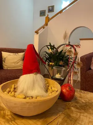 a bowl of food with a red hat on a table at Hotel Larch in Campo di Trens