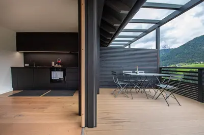 a kitchen and dining room with a table and chairs at Villa Mayr in Ortisei
