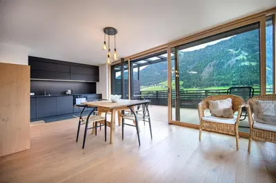 a kitchen and dining room with a table and chairs at Villa Mayr in Ortisei