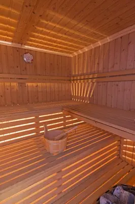 a inside of a sauna with a bucket in it at Hotel Miravalle in Soraga