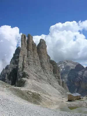 a large rocky mountain with a building in front of it at Hotel Miravalle in Soraga