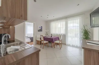 a kitchen with a table and a dining room at Quellenhof in Termeno
