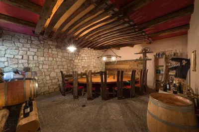 a room with a wooden table and chairs in a cellar at Quellenhof in Termeno
