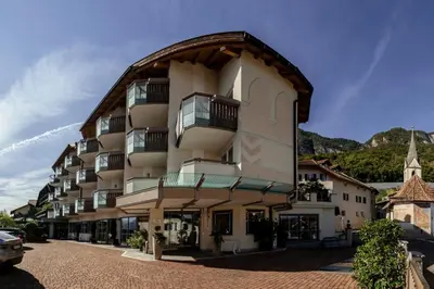a large apartment building with a gambrel roof at DAS BADL - Smart Retreat AO in Caldaro