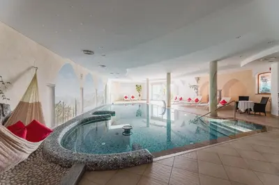 a large swimming pool in a large room at DAS BADL - Smart Retreat AO in Caldaro