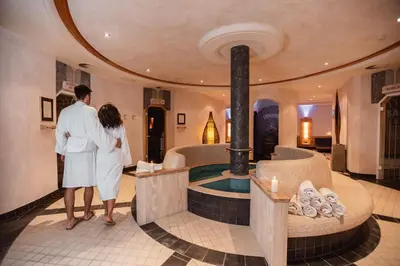 a man and woman standing in front of a hot tub at DAS BADL - Smart Retreat AO in Caldaro