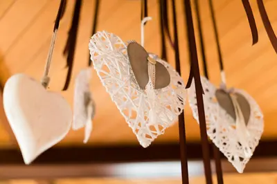 a bunch of white paper hearts hanging from a wall at DAS BADL - Smart Retreat AO in Caldaro