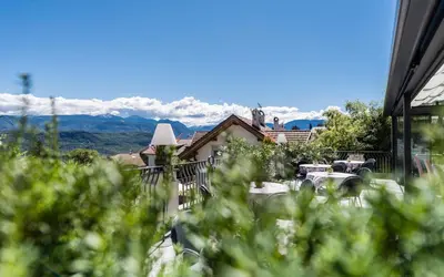 a view of a house with mountains in the background at DAS BADL - Smart Retreat AO in Caldaro