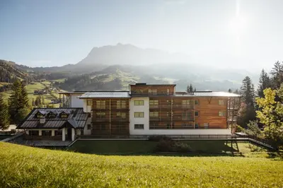 a large building with balconies and flowers on it at Hotel Melodia del Bosco in Badia