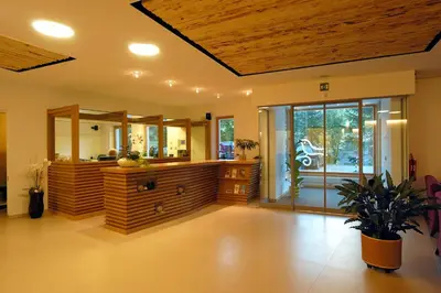 a living room with a large room with a wooden ceiling at Hotel Melodia del Bosco in Badia