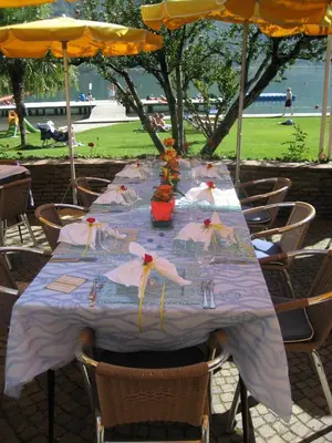 a table with a blue table cloth with flowers on it at Seegarten in Caldaro