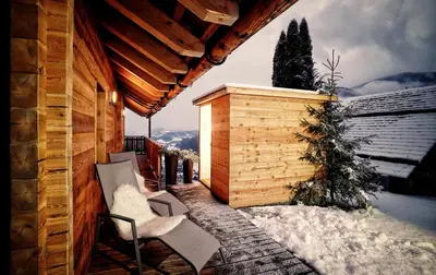 a balcony of a house with snow on the ground at Chalet Oberguggenberg in San Lorenzo di Sebato
