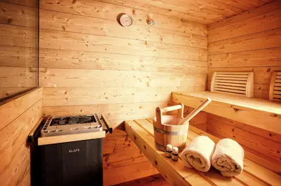 a kitchen with a stove in a wooden cabin at Chalet Oberguggenberg in San Lorenzo di Sebato