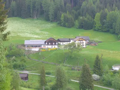 a house in the middle of a green field at Tötscherhof in Terento