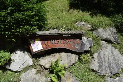 a bench on some rocks with a sign on it at Tötscherhof in Terento