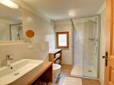 a bathroom with a sink and a glass shower at Tötscherhof in Terento