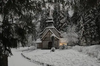 a small chapel covered in snow in a yard at Gstattlhof Mountain Farmhouse in Braies