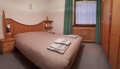 a bedroom with a bed with towels on it at Dreaming Ortisei in Ortisei