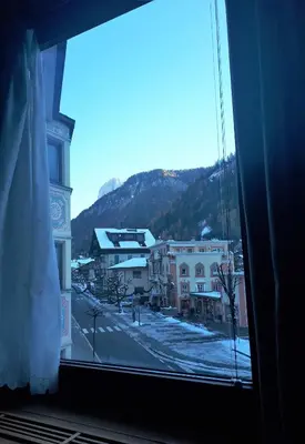 a view from a window of a town in the snow at Dreaming Ortisei in Ortisei