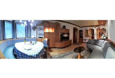 a living room with a table and a couch at Dreaming Ortisei in Ortisei