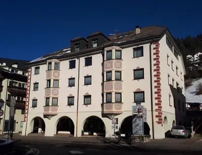a large white building with a lot of windows at Dreaming Ortisei in Ortisei