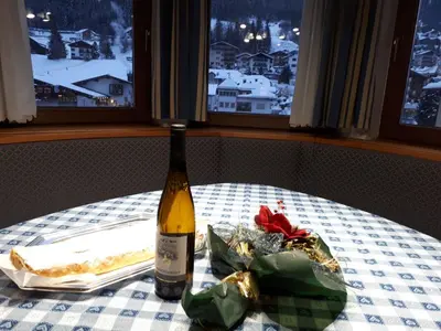 a bottle of wine sitting on top of a table at Dreaming Ortisei in Ortisei