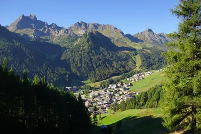 a village in a valley in the mountains at Residence Baita Antlia in Arabba