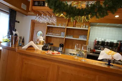 a kitchen with a counter with wine glasses at Residence Baita Antlia in Arabba