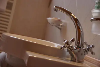 a sink with a faucet in a bathroom at Residence Baita Antlia in Arabba