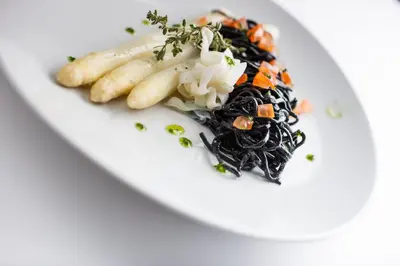 a plate of food with pasta and vegetables on it at Hotel Sparerhof in Vilpiano